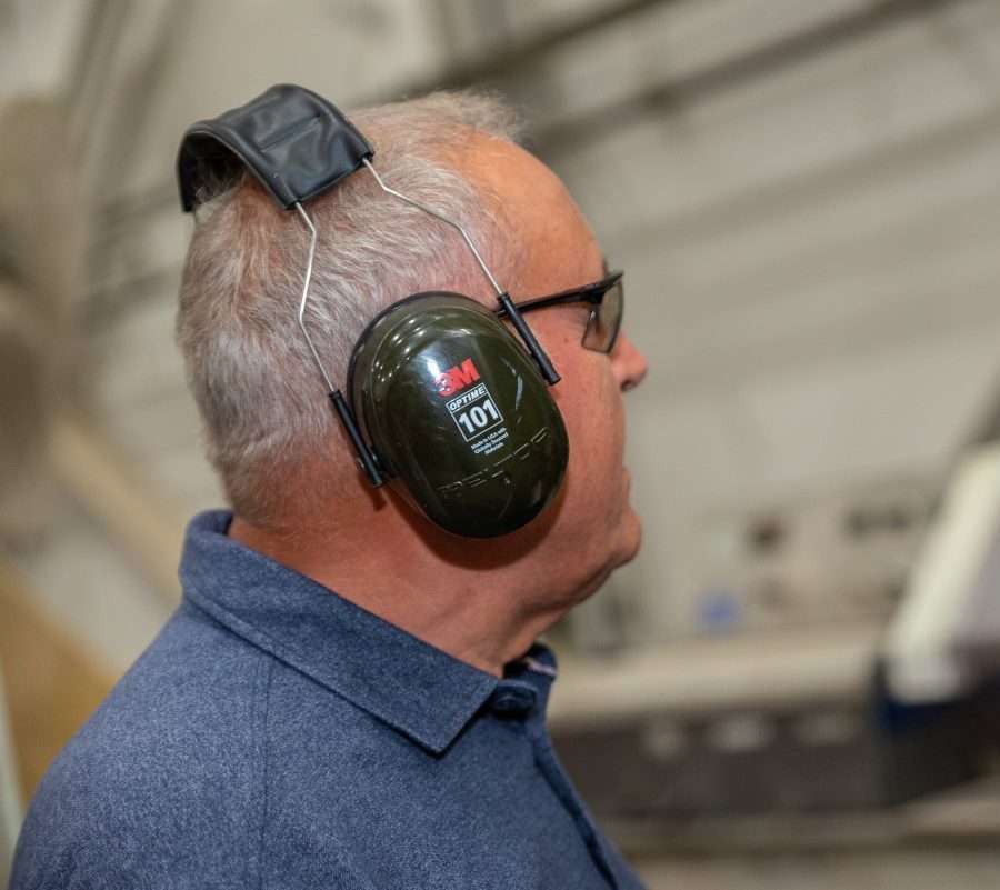 Worker wearing ear muffs