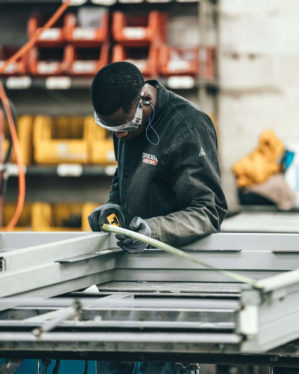 Young worker measuring.
